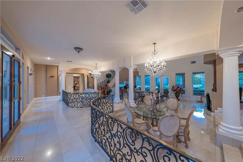 7600 Silver Meadow Court, Las Vegas, Nevada is a resort style estate in an exclusive gated enclave with a generous circular drive, a spacious living room punctuated by a stunning wrought iron floating staircase, a gourmet kitchen, venetian gardens, resort guest house and more.