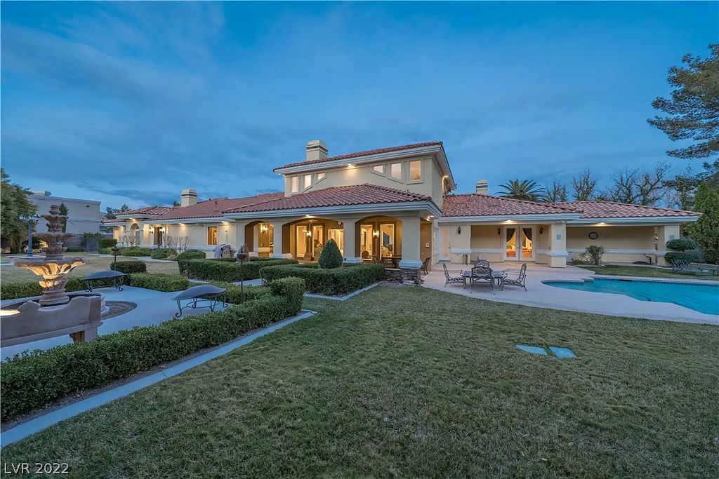 7600 Silver Meadow Court, Las Vegas, Nevada is a resort style estate in an exclusive gated enclave with a generous circular drive, a spacious living room punctuated by a stunning wrought iron floating staircase, a gourmet kitchen, venetian gardens, resort guest house and more.