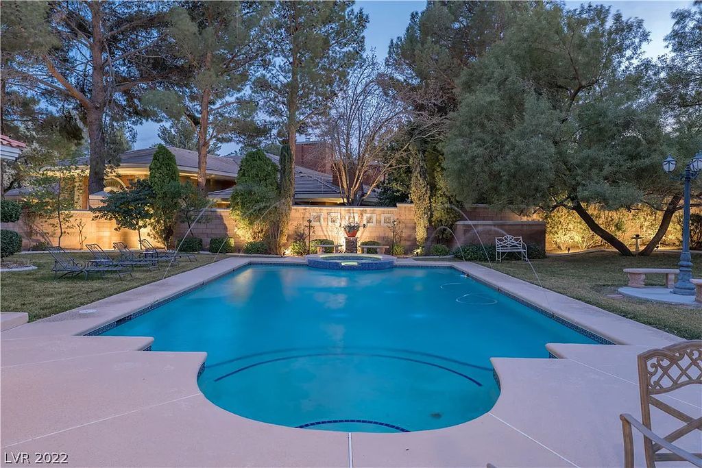 7600 Silver Meadow Court, Las Vegas, Nevada is a resort style estate in an exclusive gated enclave with a generous circular drive, a spacious living room punctuated by a stunning wrought iron floating staircase, a gourmet kitchen, venetian gardens, resort guest house and more.