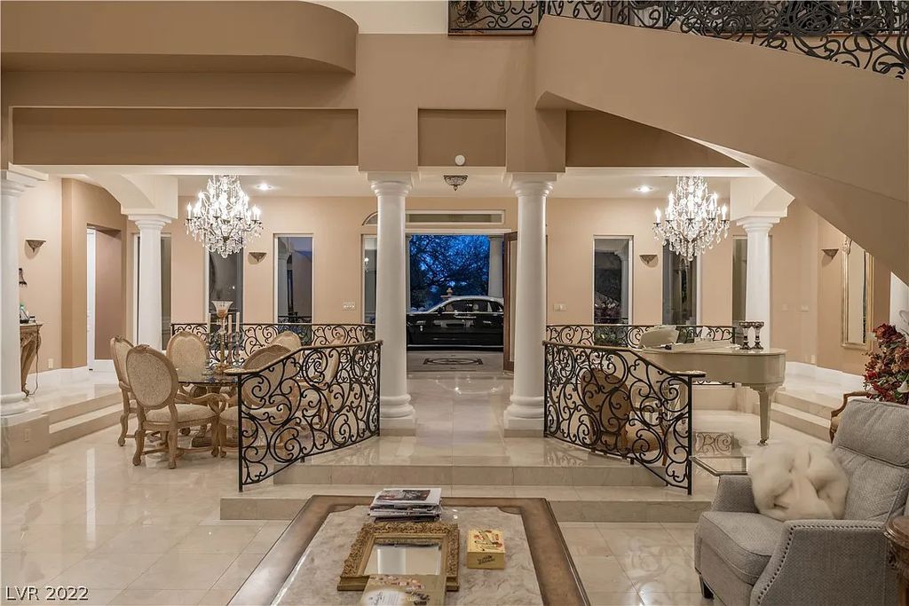 7600 Silver Meadow Court, Las Vegas, Nevada is a resort style estate in an exclusive gated enclave with a generous circular drive, a spacious living room punctuated by a stunning wrought iron floating staircase, a gourmet kitchen, venetian gardens, resort guest house and more.