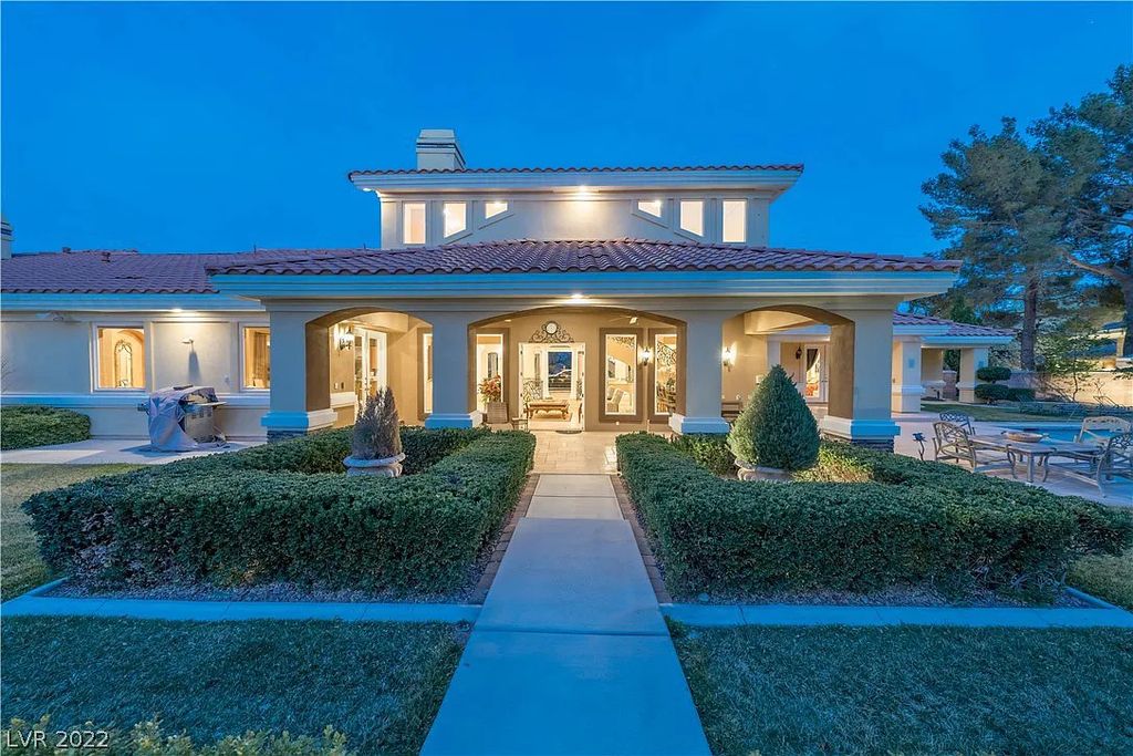 7600 Silver Meadow Court, Las Vegas, Nevada is a resort style estate in an exclusive gated enclave with a generous circular drive, a spacious living room punctuated by a stunning wrought iron floating staircase, a gourmet kitchen, venetian gardens, resort guest house and more.