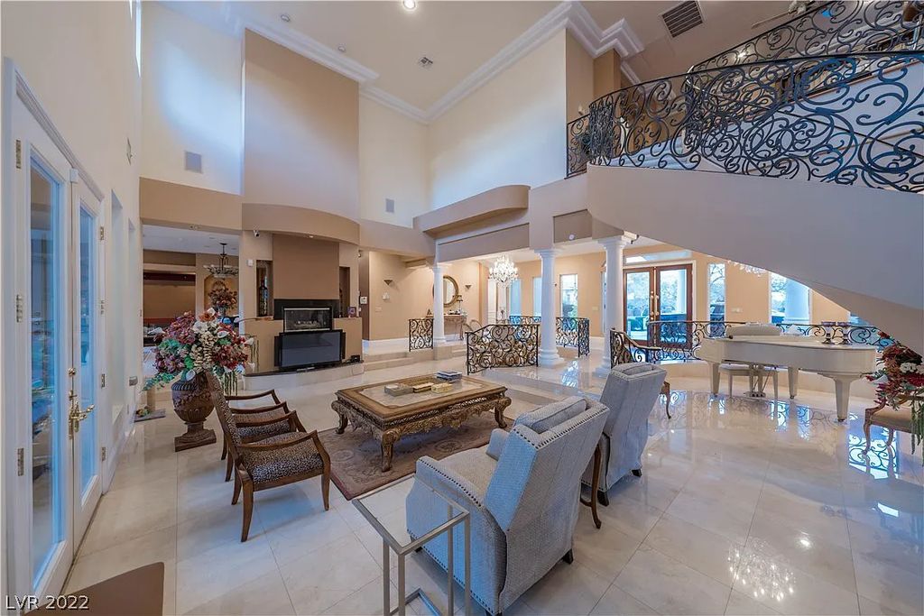 7600 Silver Meadow Court, Las Vegas, Nevada is a resort style estate in an exclusive gated enclave with a generous circular drive, a spacious living room punctuated by a stunning wrought iron floating staircase, a gourmet kitchen, venetian gardens, resort guest house and more.