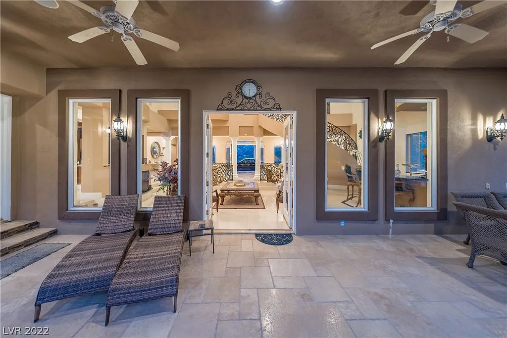 7600 Silver Meadow Court, Las Vegas, Nevada is a resort style estate in an exclusive gated enclave with a generous circular drive, a spacious living room punctuated by a stunning wrought iron floating staircase, a gourmet kitchen, venetian gardens, resort guest house and more.