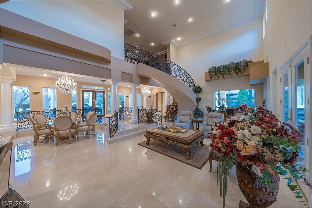 7600 Silver Meadow Court, Las Vegas, Nevada is a resort style estate in an exclusive gated enclave with a generous circular drive, a spacious living room punctuated by a stunning wrought iron floating staircase, a gourmet kitchen, venetian gardens, resort guest house and more.