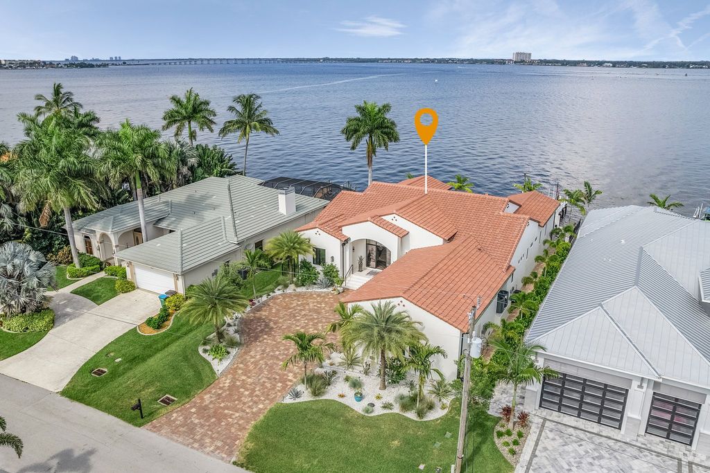 5661 Riverside Drive, Cape Coral, Florida is a meticulously maintained property with uncompromising quality include white oak flooring throughout, PGT aluminum Impact windows and doors, Wolf & Subzero appliances, Pentair filtered water system for water & ice maker in the massive Butler's Pantry with double beverage fridges, Walnut Waterfall Island sitting area, & much more. 