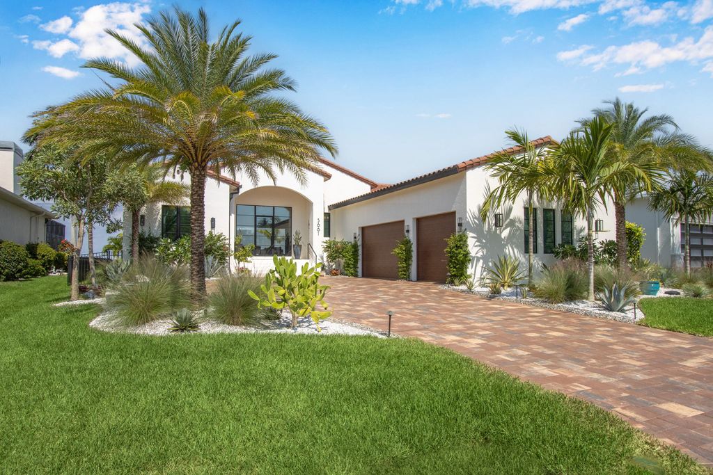 5661 Riverside Drive, Cape Coral, Florida is a meticulously maintained property with uncompromising quality include white oak flooring throughout, PGT aluminum Impact windows and doors, Wolf & Subzero appliances, Pentair filtered water system for water & ice maker in the massive Butler's Pantry with double beverage fridges, Walnut Waterfall Island sitting area, & much more. 