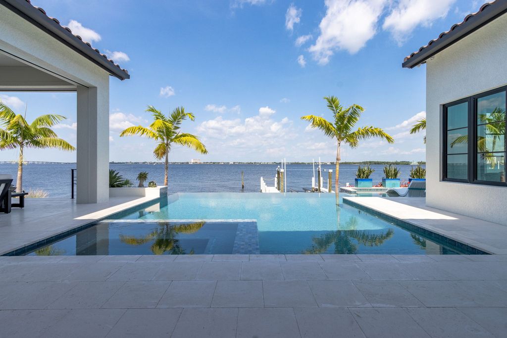 5661 Riverside Drive, Cape Coral, Florida is a meticulously maintained property with uncompromising quality include white oak flooring throughout, PGT aluminum Impact windows and doors, Wolf & Subzero appliances, Pentair filtered water system for water & ice maker in the massive Butler's Pantry with double beverage fridges, Walnut Waterfall Island sitting area, & much more. 