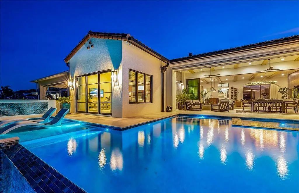 5661 Riverside Drive, Cape Coral, Florida is a meticulously maintained property with uncompromising quality include white oak flooring throughout, PGT aluminum Impact windows and doors, Wolf & Subzero appliances, Pentair filtered water system for water & ice maker in the massive Butler's Pantry with double beverage fridges, Walnut Waterfall Island sitting area, & much more. 