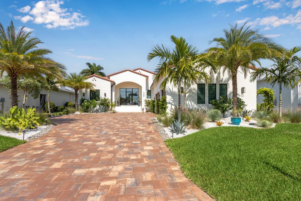 5661 Riverside Drive, Cape Coral, Florida is a meticulously maintained property with uncompromising quality include white oak flooring throughout, PGT aluminum Impact windows and doors, Wolf & Subzero appliances, Pentair filtered water system for water & ice maker in the massive Butler's Pantry with double beverage fridges, Walnut Waterfall Island sitting area, & much more. 