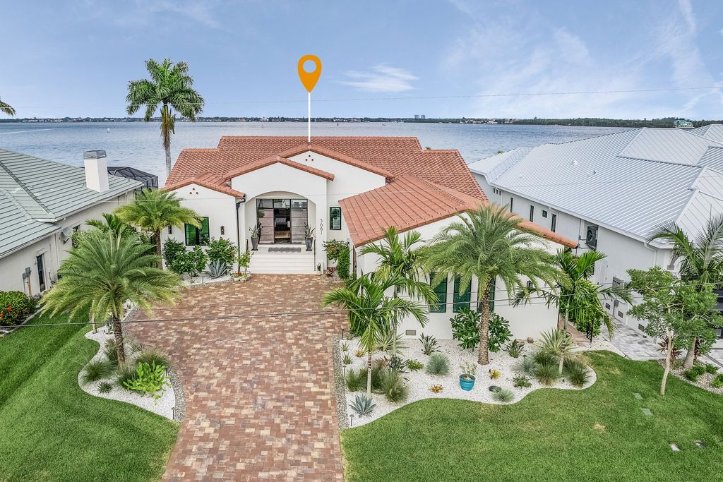 5661 Riverside Drive, Cape Coral, Florida is a meticulously maintained property with uncompromising quality include white oak flooring throughout, PGT aluminum Impact windows and doors, Wolf & Subzero appliances, Pentair filtered water system for water & ice maker in the massive Butler's Pantry with double beverage fridges, Walnut Waterfall Island sitting area, & much more. 