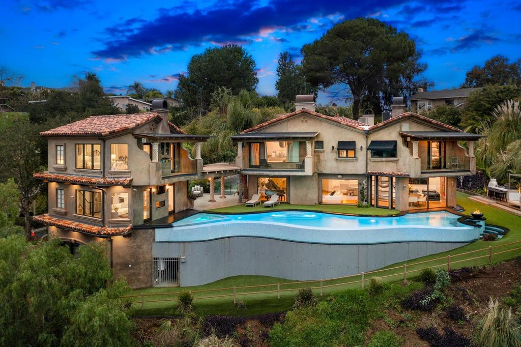 16479 Royal Hills Drive, Encino, California is a true private compound features a stunning main house, luxurious detached guest house, expansive resort type backyard and a unique art inspired swimmers infinity pool and spa that forge an effortless connection with jaw-dropping views.
