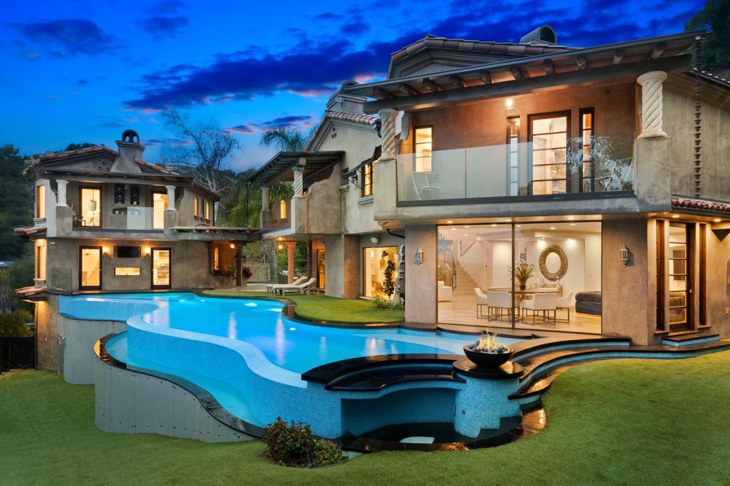 16479 Royal Hills Drive, Encino, California is a true private compound features a stunning main house, luxurious detached guest house, expansive resort type backyard and a unique art inspired swimmers infinity pool and spa that forge an effortless connection with jaw-dropping views.