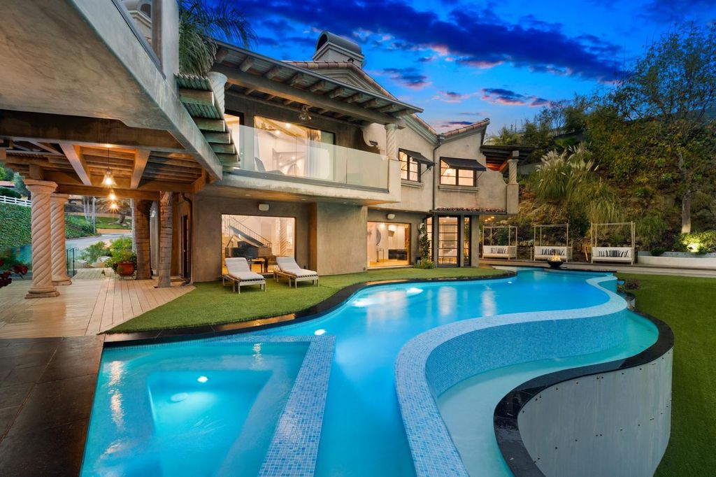 16479 Royal Hills Drive, Encino, California is a true private compound features a stunning main house, luxurious detached guest house, expansive resort type backyard and a unique art inspired swimmers infinity pool and spa that forge an effortless connection with jaw-dropping views.