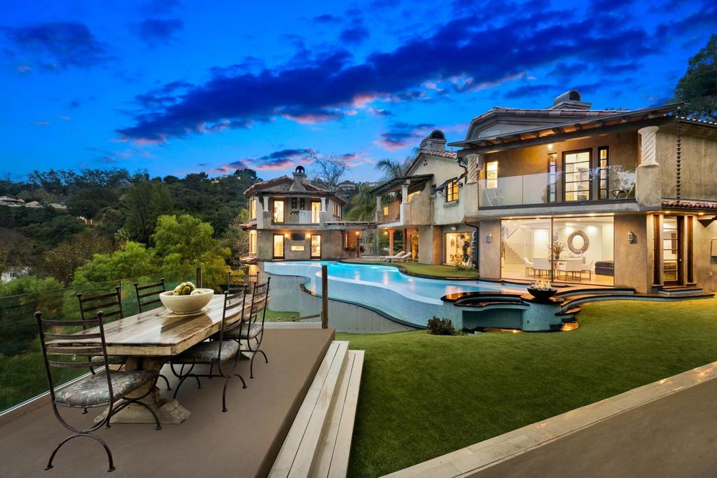 16479 Royal Hills Drive, Encino, California is a true private compound features a stunning main house, luxurious detached guest house, expansive resort type backyard and a unique art inspired swimmers infinity pool and spa that forge an effortless connection with jaw-dropping views.