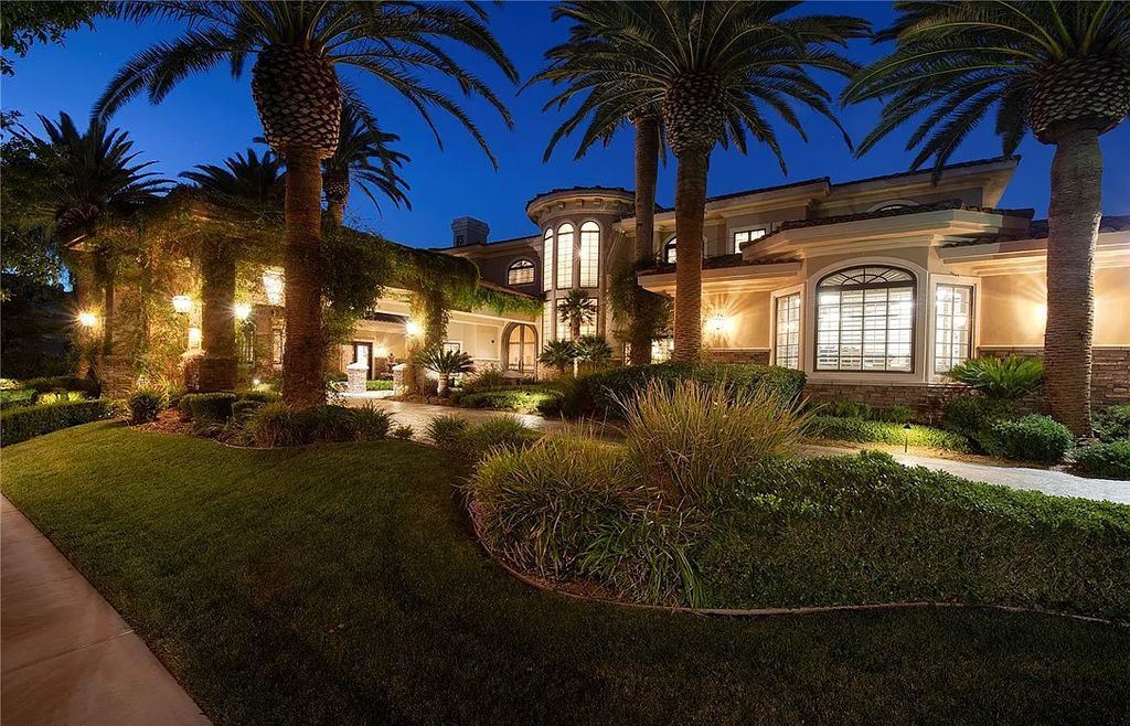 8920 Players Club Drive, Las Vegas, Nevada is a sprawling estate designed for entertaining on a grand scale with soaring ceiling heights, expansive entry, and ornate marble and carpet floor patterns.