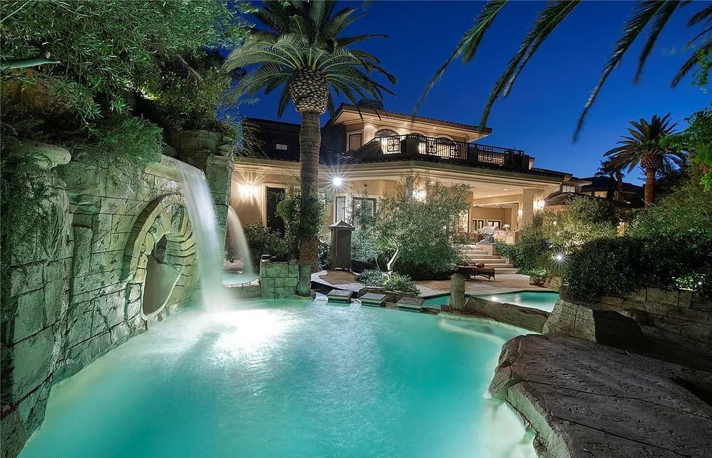 8920 Players Club Drive, Las Vegas, Nevada is a sprawling estate designed for entertaining on a grand scale with soaring ceiling heights, expansive entry, and ornate marble and carpet floor patterns.