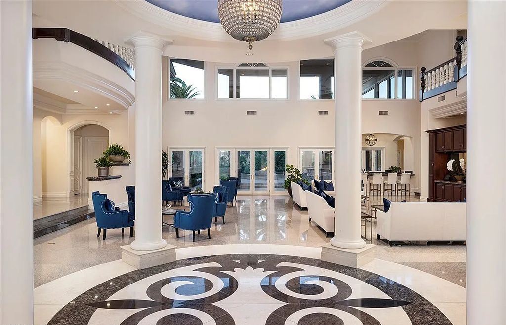 8920 Players Club Drive, Las Vegas, Nevada is a sprawling estate designed for entertaining on a grand scale with soaring ceiling heights, expansive entry, and ornate marble and carpet floor patterns.