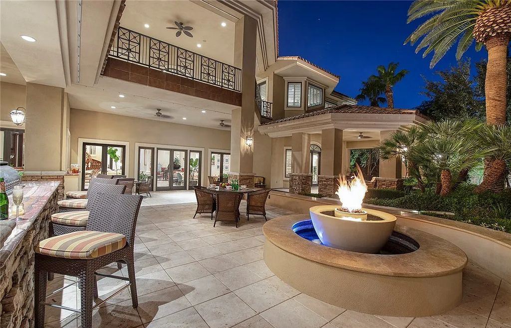 8920 Players Club Drive, Las Vegas, Nevada is a sprawling estate designed for entertaining on a grand scale with soaring ceiling heights, expansive entry, and ornate marble and carpet floor patterns.