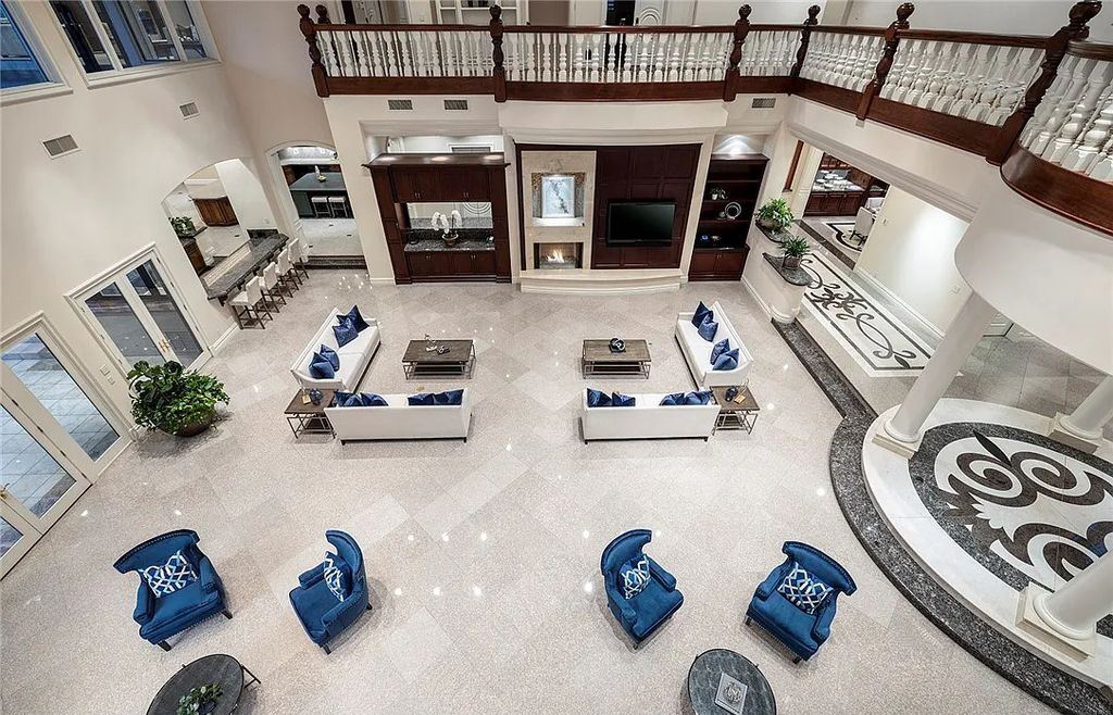 8920 Players Club Drive, Las Vegas, Nevada is a sprawling estate designed for entertaining on a grand scale with soaring ceiling heights, expansive entry, and ornate marble and carpet floor patterns.