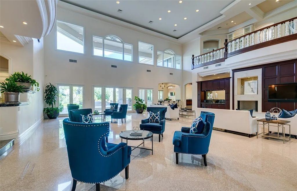 8920 Players Club Drive, Las Vegas, Nevada is a sprawling estate designed for entertaining on a grand scale with soaring ceiling heights, expansive entry, and ornate marble and carpet floor patterns.