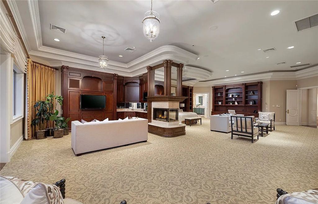 8920 Players Club Drive, Las Vegas, Nevada is a sprawling estate designed for entertaining on a grand scale with soaring ceiling heights, expansive entry, and ornate marble and carpet floor patterns.