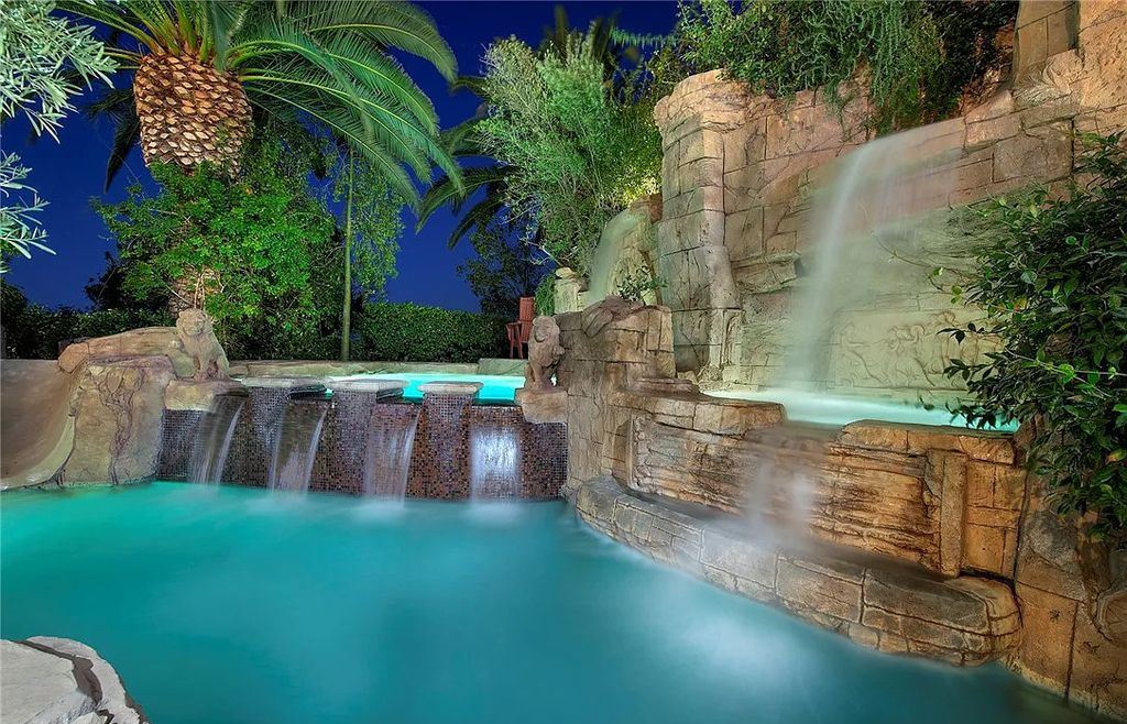 8920 Players Club Drive, Las Vegas, Nevada is a sprawling estate designed for entertaining on a grand scale with soaring ceiling heights, expansive entry, and ornate marble and carpet floor patterns.