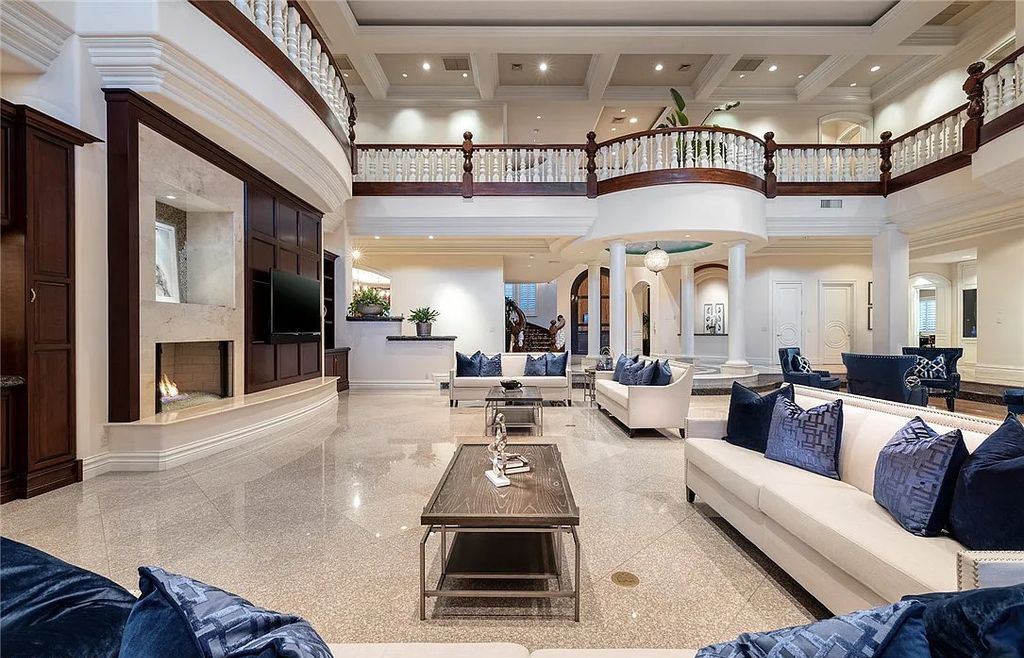 8920 Players Club Drive, Las Vegas, Nevada is a sprawling estate designed for entertaining on a grand scale with soaring ceiling heights, expansive entry, and ornate marble and carpet floor patterns.