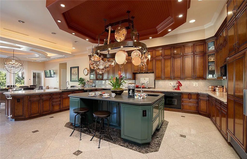 8920 Players Club Drive, Las Vegas, Nevada is a sprawling estate designed for entertaining on a grand scale with soaring ceiling heights, expansive entry, and ornate marble and carpet floor patterns.