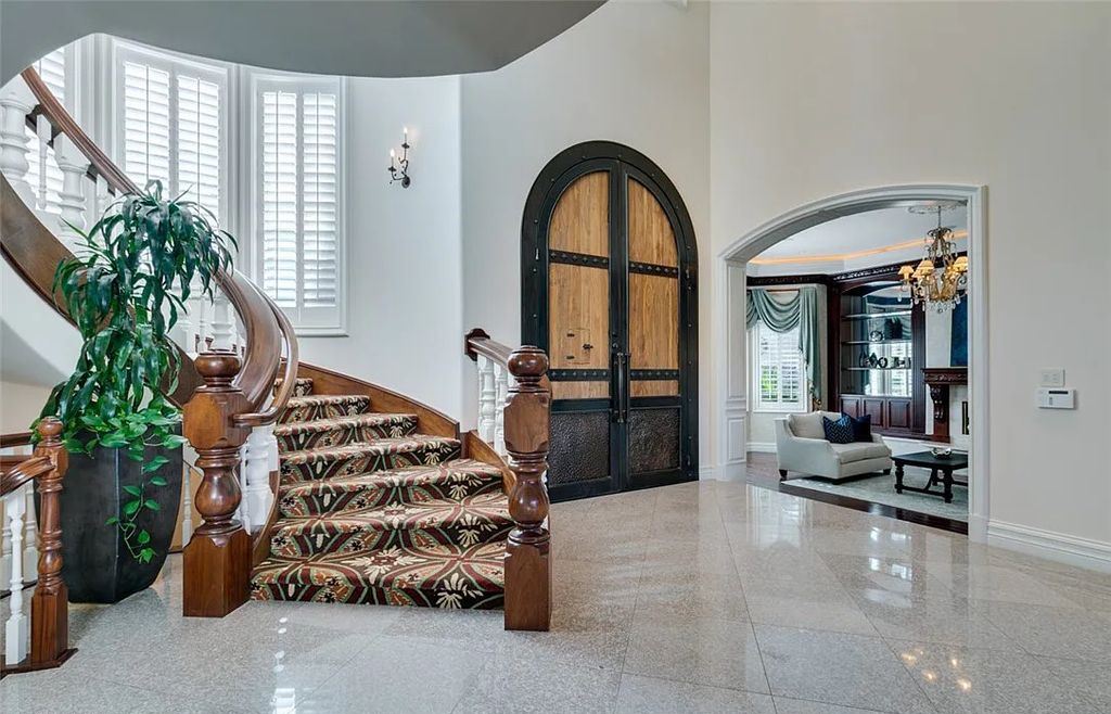 8920 Players Club Drive, Las Vegas, Nevada is a sprawling estate designed for entertaining on a grand scale with soaring ceiling heights, expansive entry, and ornate marble and carpet floor patterns.