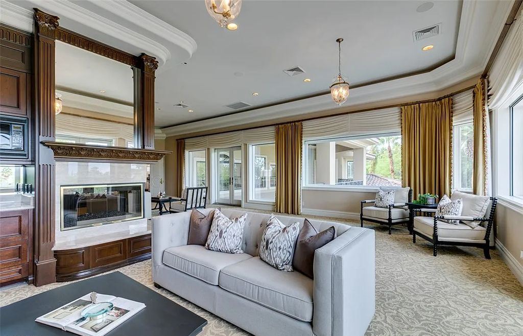 8920 Players Club Drive, Las Vegas, Nevada is a sprawling estate designed for entertaining on a grand scale with soaring ceiling heights, expansive entry, and ornate marble and carpet floor patterns.