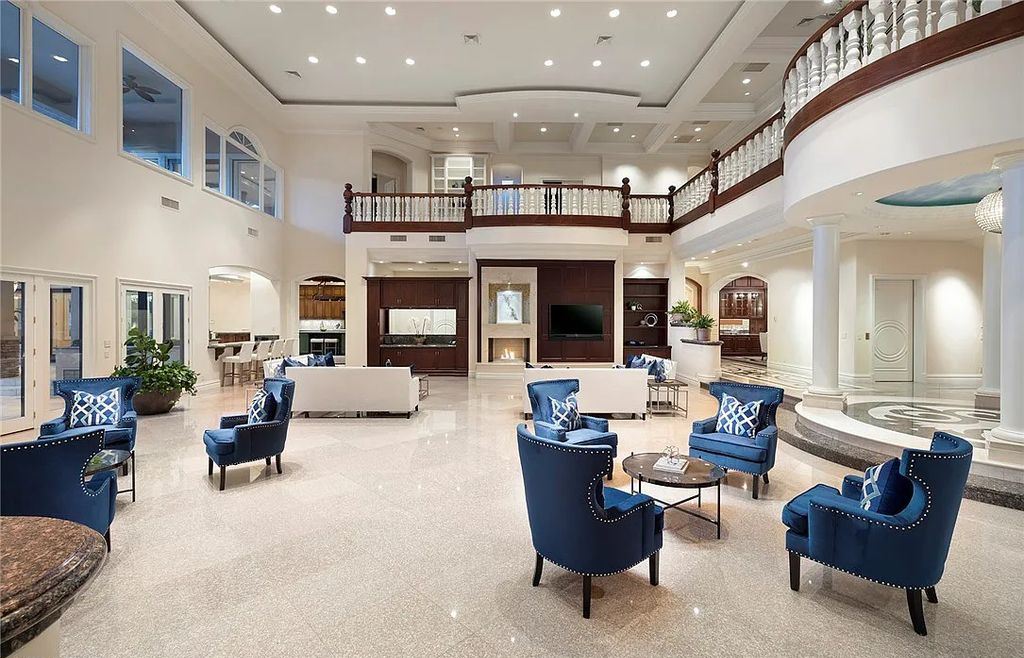 8920 Players Club Drive, Las Vegas, Nevada is a sprawling estate designed for entertaining on a grand scale with soaring ceiling heights, expansive entry, and ornate marble and carpet floor patterns.