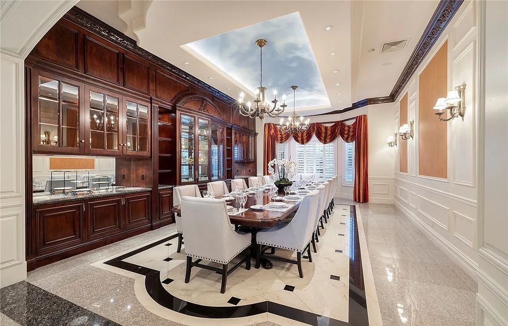 8920 Players Club Drive, Las Vegas, Nevada is a sprawling estate designed for entertaining on a grand scale with soaring ceiling heights, expansive entry, and ornate marble and carpet floor patterns.