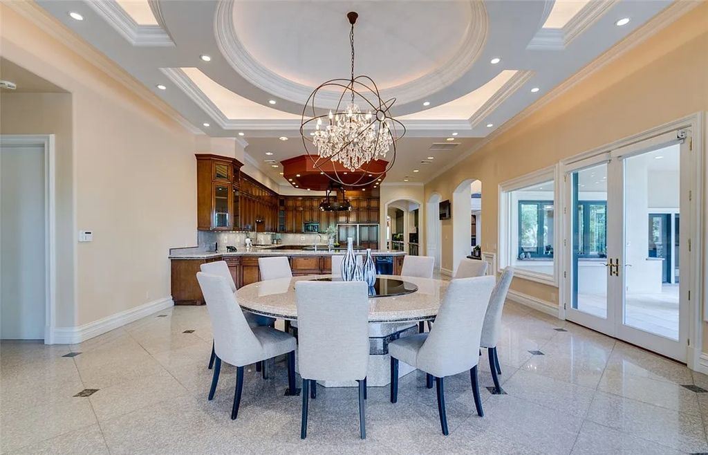 8920 Players Club Drive, Las Vegas, Nevada is a sprawling estate designed for entertaining on a grand scale with soaring ceiling heights, expansive entry, and ornate marble and carpet floor patterns.