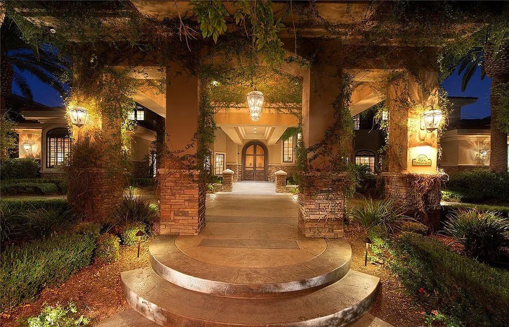 8920 Players Club Drive, Las Vegas, Nevada is a sprawling estate designed for entertaining on a grand scale with soaring ceiling heights, expansive entry, and ornate marble and carpet floor patterns.