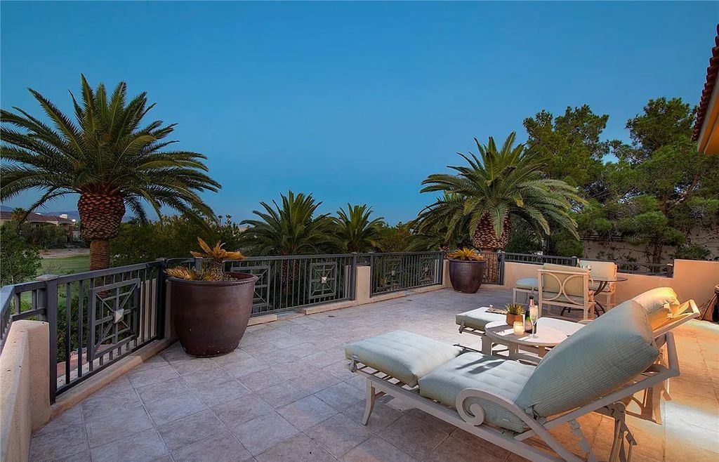 8920 Players Club Drive, Las Vegas, Nevada is a sprawling estate designed for entertaining on a grand scale with soaring ceiling heights, expansive entry, and ornate marble and carpet floor patterns.