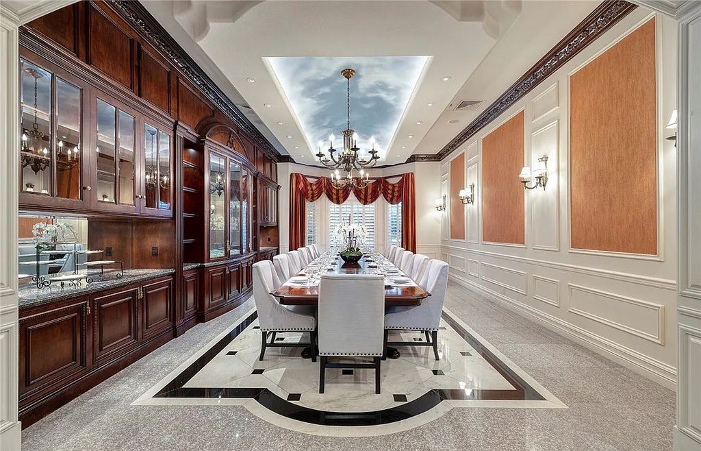 8920 Players Club Drive, Las Vegas, Nevada is a sprawling estate designed for entertaining on a grand scale with soaring ceiling heights, expansive entry, and ornate marble and carpet floor patterns.
