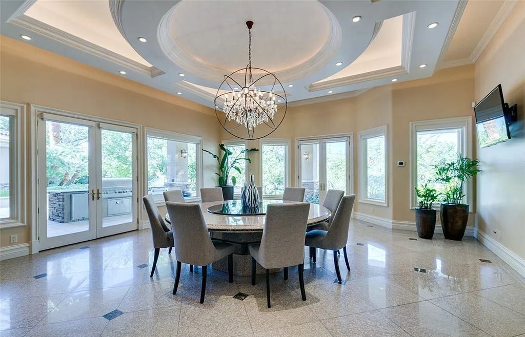 8920 Players Club Drive, Las Vegas, Nevada is a sprawling estate designed for entertaining on a grand scale with soaring ceiling heights, expansive entry, and ornate marble and carpet floor patterns.