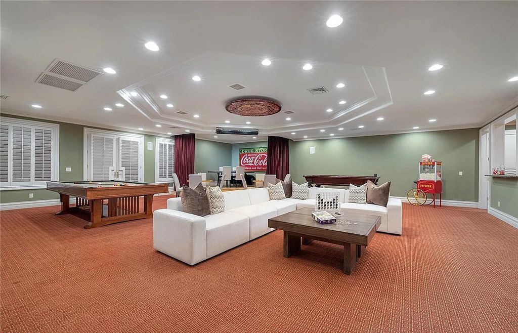 8920 Players Club Drive, Las Vegas, Nevada is a sprawling estate designed for entertaining on a grand scale with soaring ceiling heights, expansive entry, and ornate marble and carpet floor patterns.