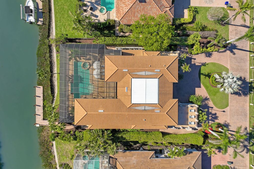1450 Gulfstar Drive South, Naples, Florida is an impressive home combining the ultimate in interior finishes and exterior amenities, over 4,800 square feet of outdoor living area, unmatched design and exquisite finishes throughout.