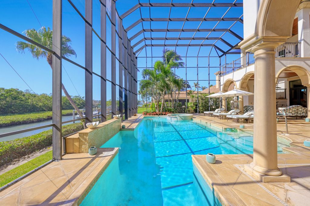1450 Gulfstar Drive South, Naples, Florida is an impressive home combining the ultimate in interior finishes and exterior amenities, over 4,800 square feet of outdoor living area, unmatched design and exquisite finishes throughout.