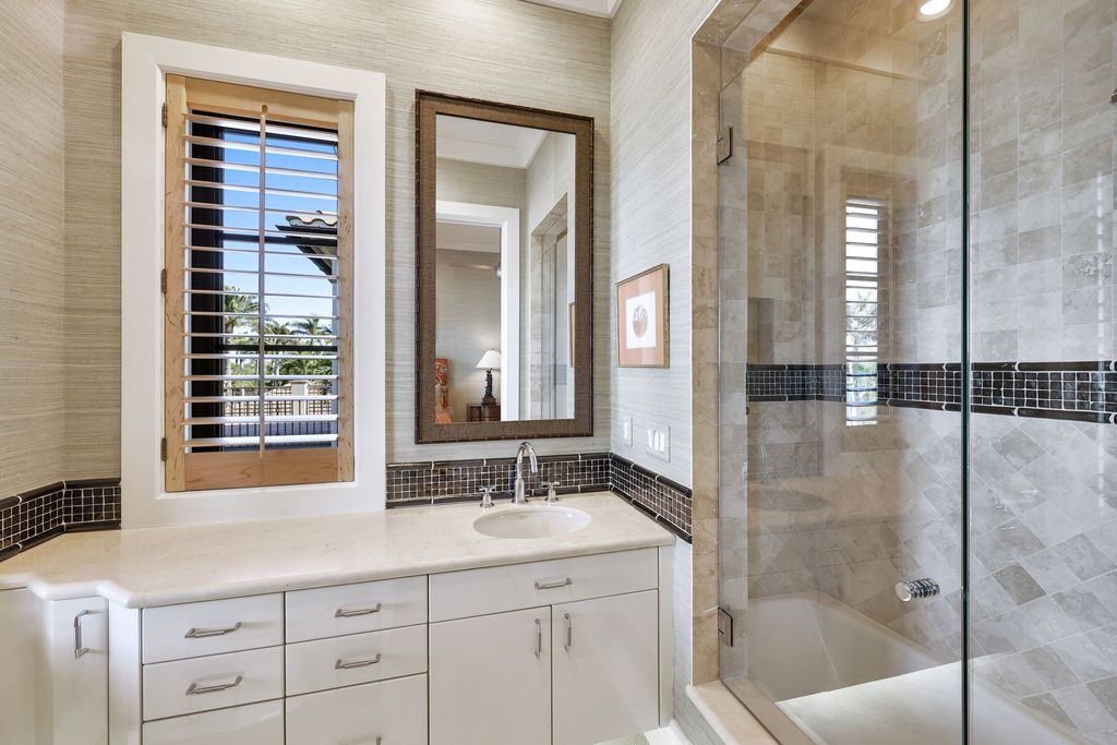 1450 Gulfstar Drive South, Naples, Florida is an impressive home combining the ultimate in interior finishes and exterior amenities, over 4,800 square feet of outdoor living area, unmatched design and exquisite finishes throughout.