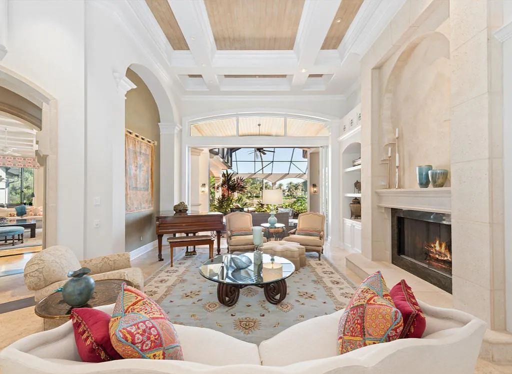 26079 Fawnwood Court, Bonita Springs, Florida, is a beautiful lakefront home built on a prominent corner lot in desirable Spring Ridge. With warm and inviting décor and a separate waterfall flowing into a tropical lagoon pool, it is a timeless design.