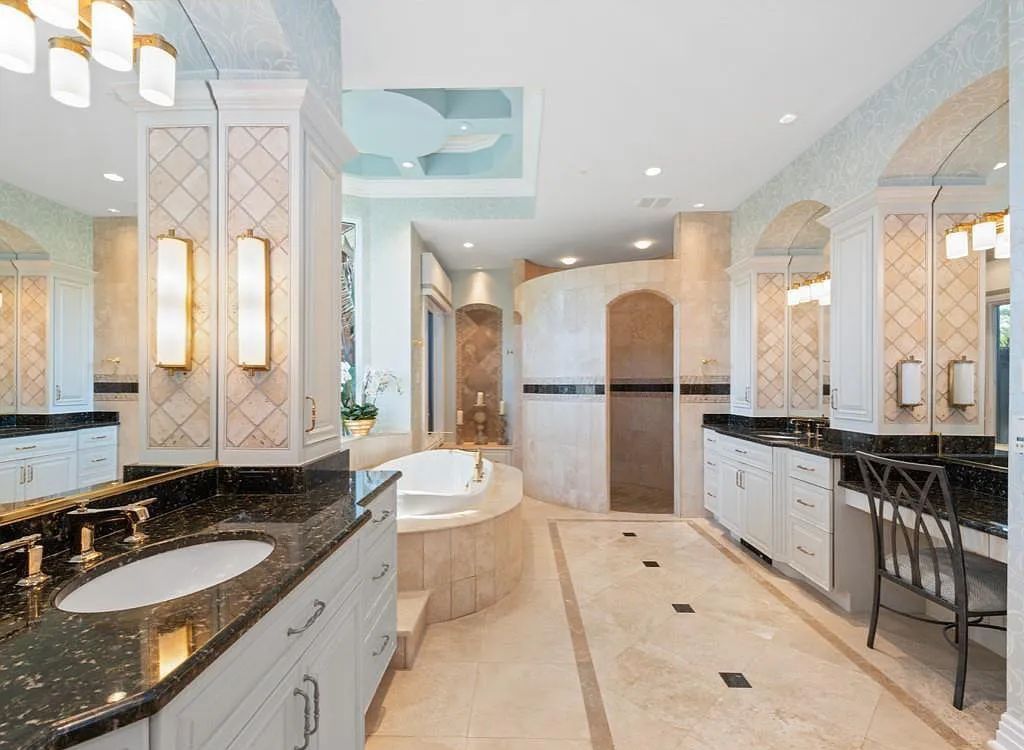 26079 Fawnwood Court, Bonita Springs, Florida, is a beautiful lakefront home built on a prominent corner lot in desirable Spring Ridge. With warm and inviting décor and a separate waterfall flowing into a tropical lagoon pool, it is a timeless design.