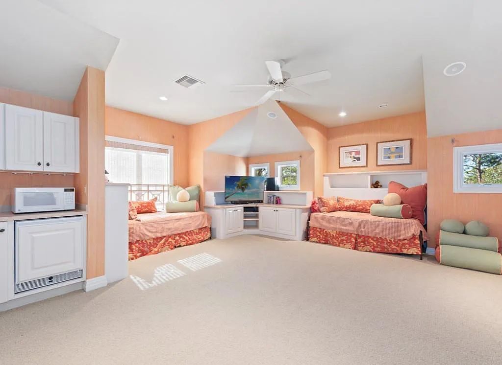 26079 Fawnwood Court, Bonita Springs, Florida, is a beautiful lakefront home built on a prominent corner lot in desirable Spring Ridge. With warm and inviting décor and a separate waterfall flowing into a tropical lagoon pool, it is a timeless design.