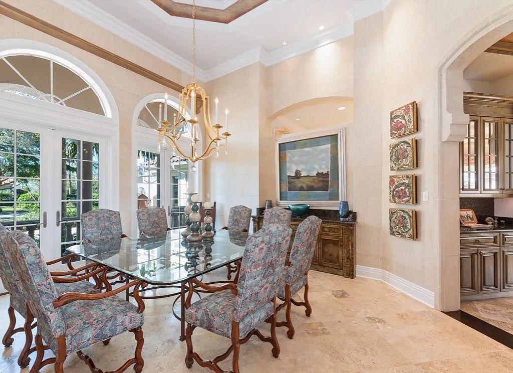 26079 Fawnwood Court, Bonita Springs, Florida, is a beautiful lakefront home built on a prominent corner lot in desirable Spring Ridge. With warm and inviting décor and a separate waterfall flowing into a tropical lagoon pool, it is a timeless design.