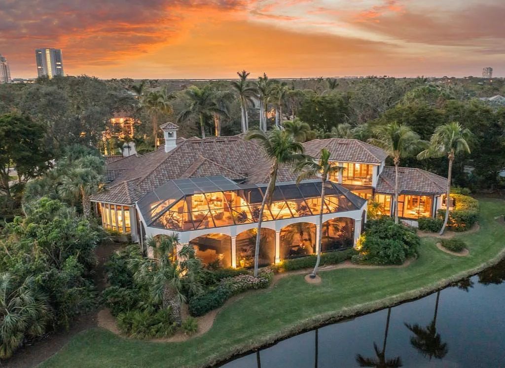 26079 Fawnwood Court, Bonita Springs, Florida, is a beautiful lakefront home built on a prominent corner lot in desirable Spring Ridge. With warm and inviting décor and a separate waterfall flowing into a tropical lagoon pool, it is a timeless design.