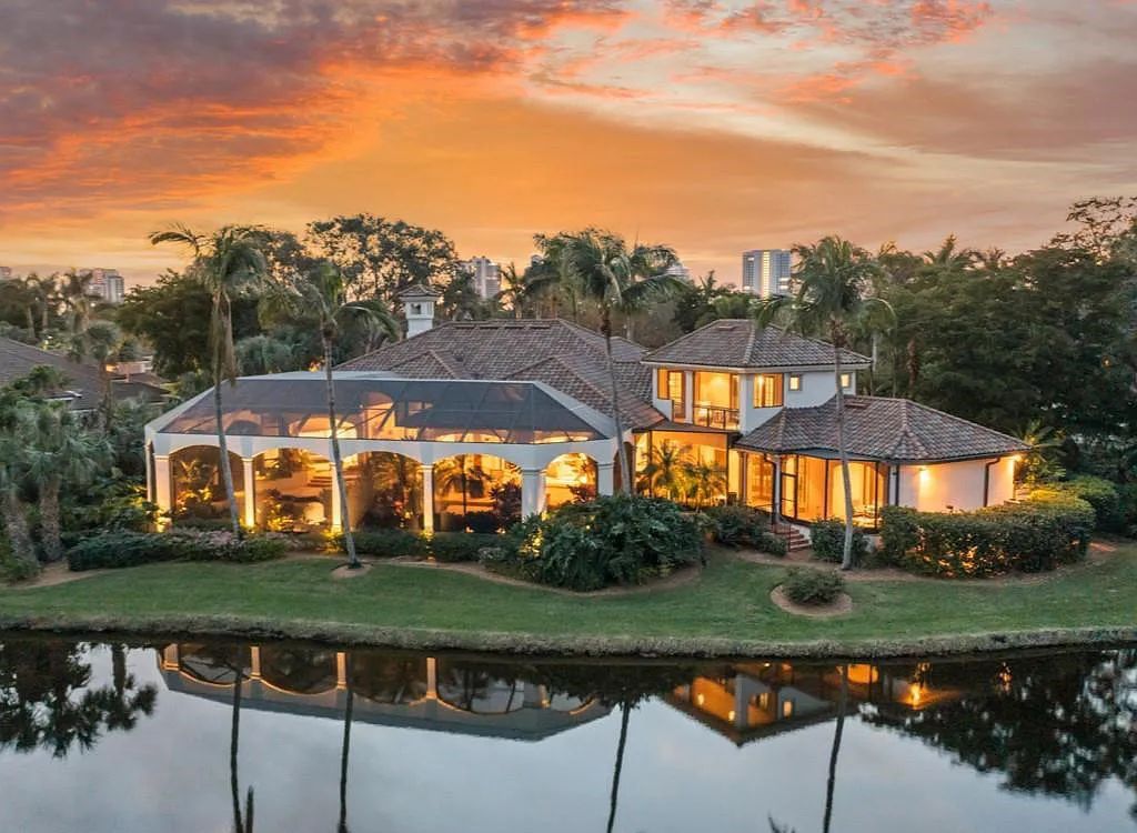 26079 Fawnwood Court, Bonita Springs, Florida, is a beautiful lakefront home built on a prominent corner lot in desirable Spring Ridge. With warm and inviting décor and a separate waterfall flowing into a tropical lagoon pool, it is a timeless design.