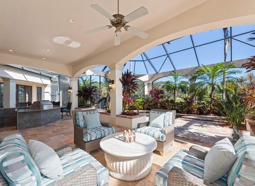 26079 Fawnwood Court, Bonita Springs, Florida, is a beautiful lakefront home built on a prominent corner lot in desirable Spring Ridge. With warm and inviting décor and a separate waterfall flowing into a tropical lagoon pool, it is a timeless design.