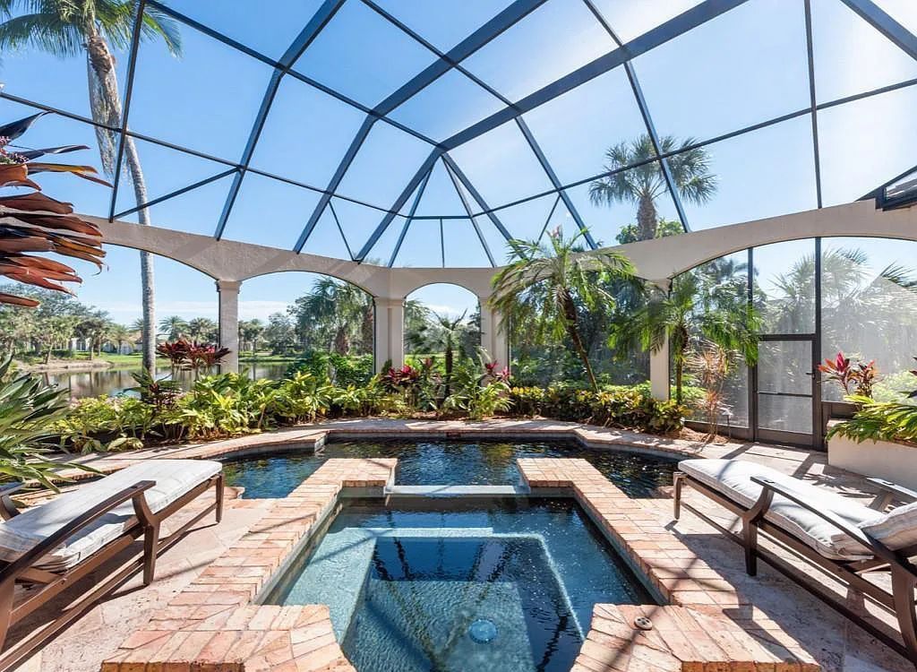26079 Fawnwood Court, Bonita Springs, Florida, is a beautiful lakefront home built on a prominent corner lot in desirable Spring Ridge. With warm and inviting décor and a separate waterfall flowing into a tropical lagoon pool, it is a timeless design.