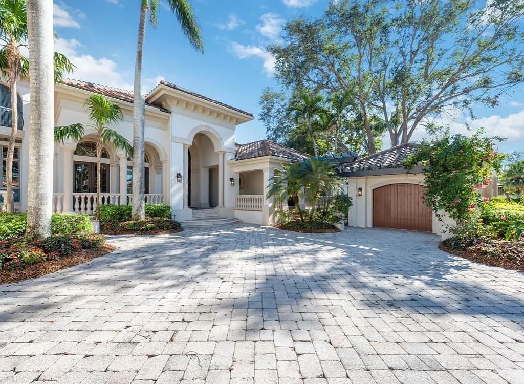 26079 Fawnwood Court, Bonita Springs, Florida, is a beautiful lakefront home built on a prominent corner lot in desirable Spring Ridge. With warm and inviting décor and a separate waterfall flowing into a tropical lagoon pool, it is a timeless design.